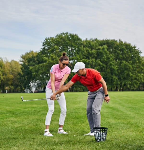 Happy lady golfer learning backswing
